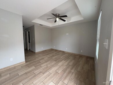 Unfurnished living room with ceiling fan with notable chandelier