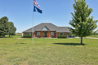View of front of property featuring a front yard, brick siding, and roof with shingles