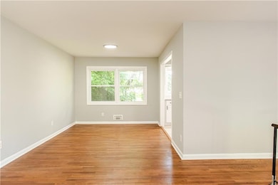 Empty room with light wood finished floors, baseboards, and recessed lighting