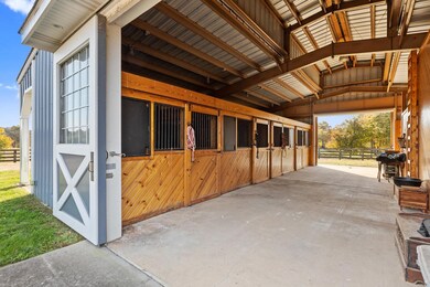 The 4 stall barn is complete with tack room, wash rack and garage.