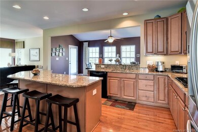 The kitchen has a center island with granite counter top that offers extra storage and work space.