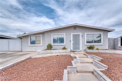 View of front of house with stucco siding and fenc