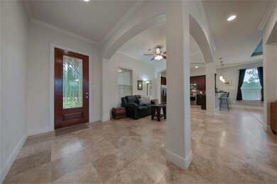 Entry is open to living spaces including formal dining, sitting room, family room and kitchen