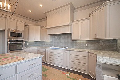Gas cooktop, walk-in pantry and granite counter to