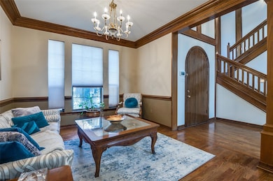 Living area featuring crown molding, an inviting c