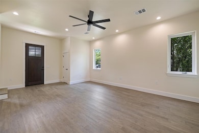 Unfurnished living room with ceiling fan, recesse