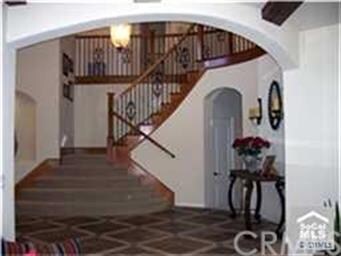 Grand entry with stone/wood floor and wrought iron