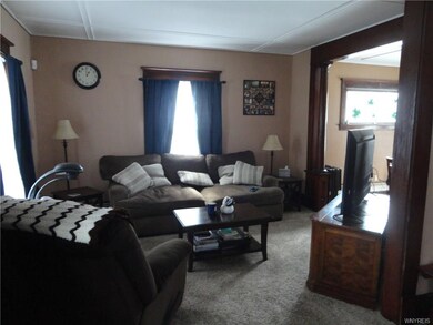 This living room is spacious and opens from foyer and into dining room. Notice the beautiful wood columns and trim!