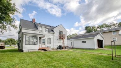 BACK OF TRIP-PLEX WITH VIEW OF BACK 2-CAR GARAGE