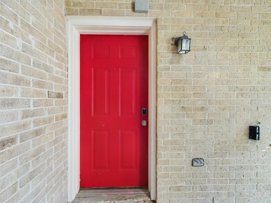 Doorway to property with brick siding