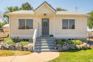 View of front facade with a shingled roof and a front yard