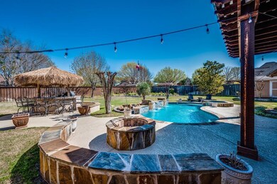 View of the outdoor kitchen cabana to your left. Built-in grill and refrigerator!