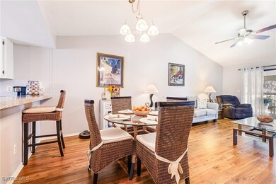 Dining area featuring lofted ceiling, light wood-t