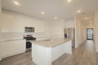 Kitchen has an island that opens to dining area