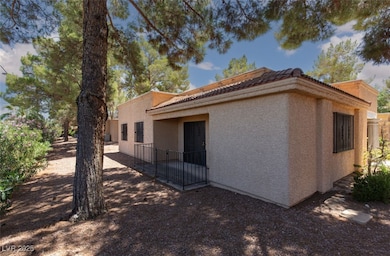 View of home's exterior with stucco siding and a tiled roof