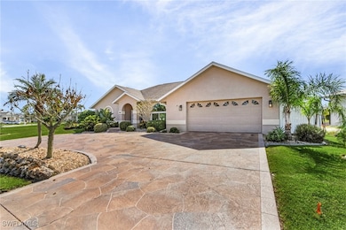 Ranch-style home featuring a garage and a front ya