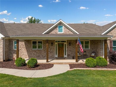 Traditional home featuring roof with shingles and brick siding