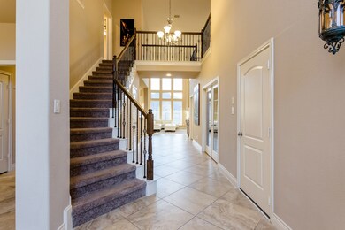 Stunning entry way with curved stair case. Throughout the downstairs living areas you will find LARGE tile diagonally laid.