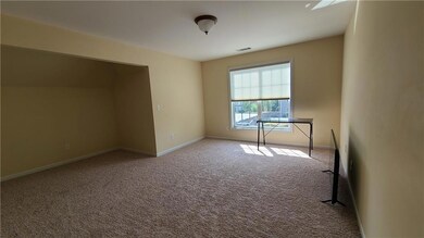 Empty room featuring visible vents, baseboards, an
