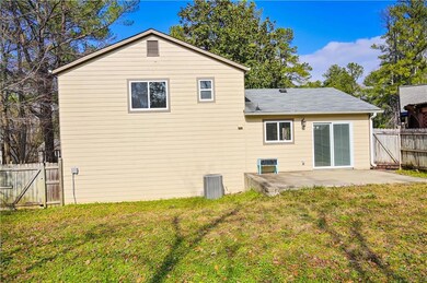 Back of house with a lawn and a patio area