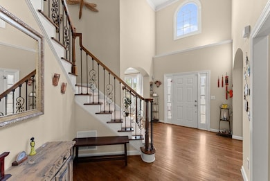 Entrance foyer featuring arched walkways, visible 