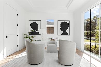 Office featuring wood finished floors and a raised ceiling