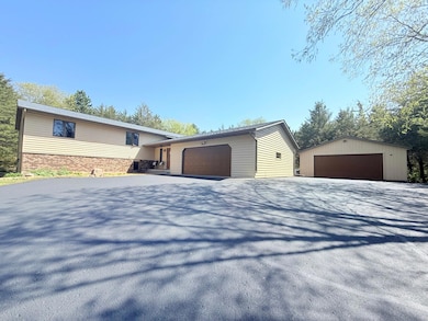 Spacious Hudson property with privacy and nature! 2-car attached and detached garages, trails, garden, and plenty of open space to explore.