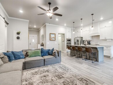 Living room with crown molding, light wood-type fl