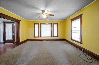 Empty room featuring a textured ceiling, crown mol