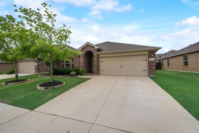 Single story home with a garage and a front lawn