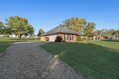 View of property exterior with concrete driveway, brick siding, a garage, and a shingled roof
