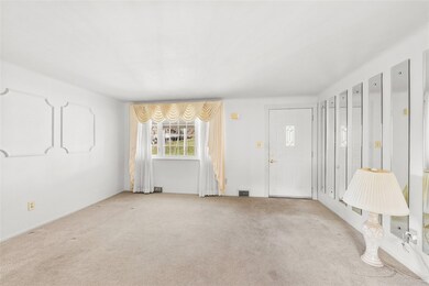 15' x 13' living room looking towards the front door entrance to the home