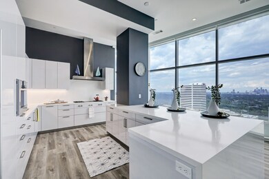 The sleek and stylish white kitchen also overlooks