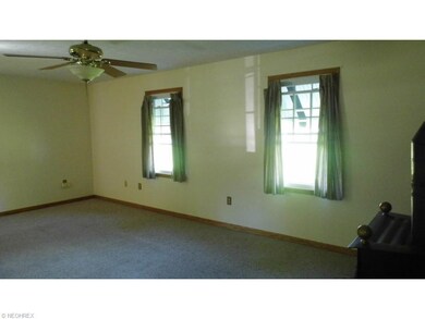 Family Room with ceiling fan and Gas Burning Stove