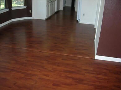 Laminate wood flooring in living room, kitchen, an