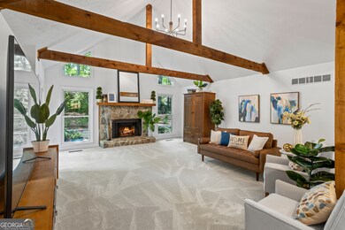 grand, vaulted ceilings with rustic wood beams, a beautiful new chandelier