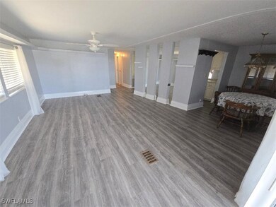 Unfurnished living room featuring wood finished fl