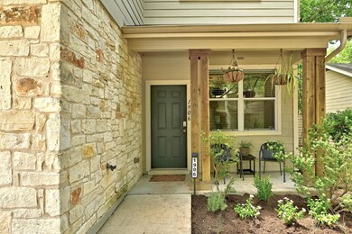 Doorway to property with stone siding and covered