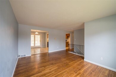 Bright Living Room looks out to treed backyard