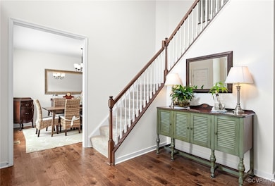 Turned open rail staircase and view into formal di
