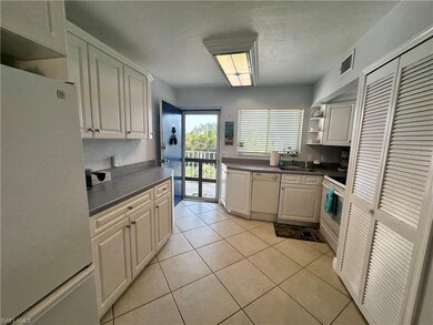 Kitchen featuring white appliances, light tile pat