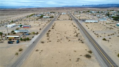 Aerial view featuring view of desert, a rural view, and a mountain view