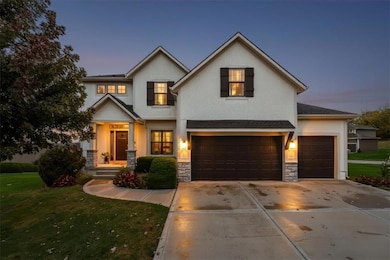 View of front of home with a front yard, stone siding, driveway, stucco siding, and a garage