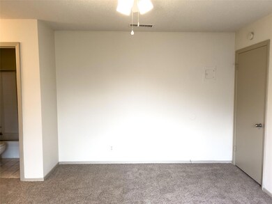 Carpeted empty room with baseboards, ceiling fan,