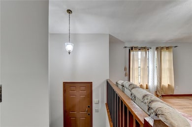 Hall featuring light wood finished floors and base