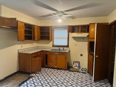 Kitchen featuring sink, light tile patterned floor