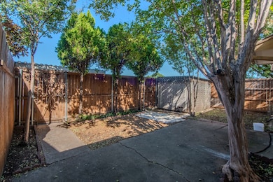 Fenced backyard with a patio and a storage unit