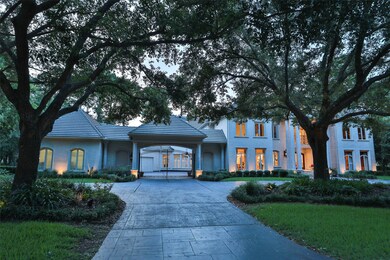 The stamped concrete double-wide circular driveway provides plenty of parking with two additional parking pads on either side of the driveway plus a large motor court inside the gated driveway that leads to an oversized four-car garage. 
