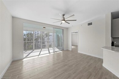 Unfurnished living room featuring ceiling fan