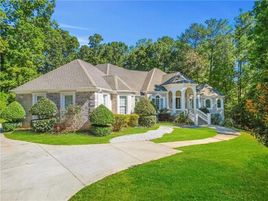 View of front of house with a porch and a front ya